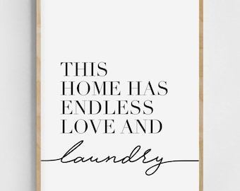 May include: Black and white typography print with the text "This home has endless love and laundry" on a white background with a wood frame.
