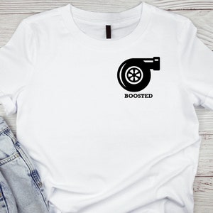 Puede incluir: Camiseta blanca con un gráfico de turbocompresor negro y la palabra "BOOSTED" impresa debajo.