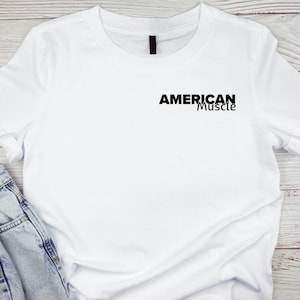 Puede incluir: Camiseta blanca con texto negro que dice "AMERICAN Muscle" en la parte delantera.