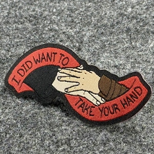 May include: Red embroidered patch with the text "I did want to take your hand" and a cartoon image of two hands holding each other.