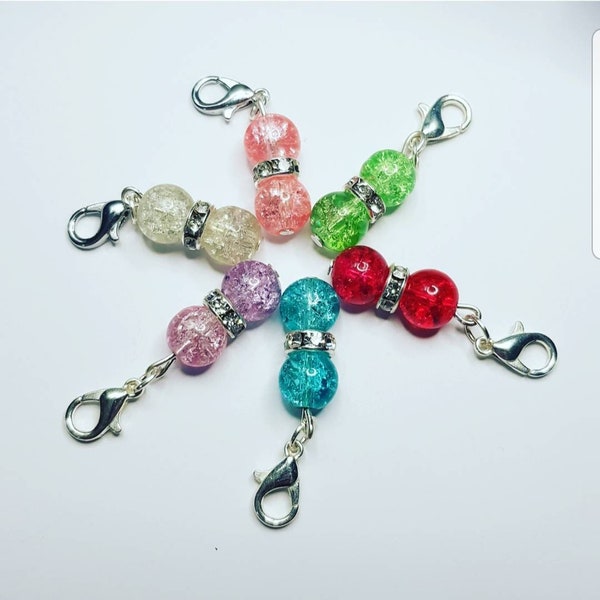 Six-piece set of yarn ball stitch markers that are handmade, snag-free, and suitable for crocheting and knitting.