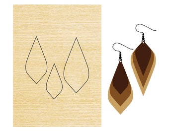 May include: Three earring templates for crafting, cut from wood. The templates are shaped like teardrops and are ready to be used for creating earrings.