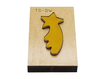 May include: A wooden craft die with the text "TS-DW" and a yellow star-shaped cutout.