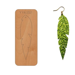 May include: A wooden die-cut template for making earrings in the shape of a feather. The template is labeled "YY6102".