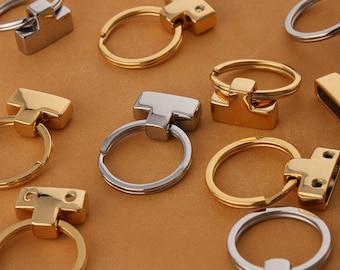 Può includere: Assortimento di portachiavi dorati e argentati con un connettore a forma di T. I portachiavi sono in metallo e hanno una finitura lucida.