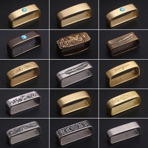 May include: A collection of 12 different belt buckle designs. The buckles are made of brass and feature various patterns and designs, including a feather, a floral pattern, and a geometric pattern. Some buckles have a turquoise stone inlay.