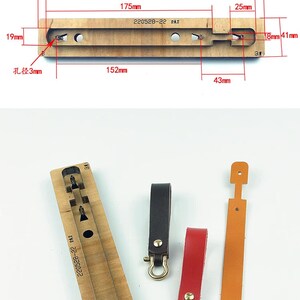 May include: A wooden leather craft tool with a metal punch for making keychains. The tool has a rectangular shape and is marked with the text "220528-22 日本刀".