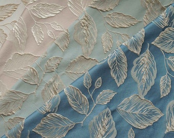May include: Three fabric swatches with a leaf pattern. The top swatch is white with gold leaves, the middle swatch is light blue with gold leaves, and the bottom swatch is teal blue with gold leaves.