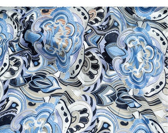 May include: An abstract textile design featuring a repeating pattern of swirling floral shapes in shades of blue, white, and gray. The design has a layered effect, with some elements appearing to be embroidered or raised.