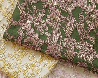 May include: Three pieces of fabric with floral patterns. The top fabric is green with pink and gold flowers. The middle fabric is white with gold flowers. The bottom fabric is white with pink and gold flowers.