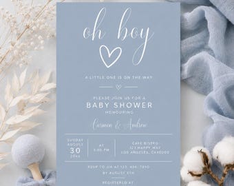 May include: A rectangular baby shower invitation card in dusty blue with white text reading oh boy, a little one is on the way, please join us for a baby shower honouring Carmen & Andrew, Sunday August 30 20xx, at 3:00 pm, Cafe Bistro.