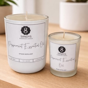 May include: Two white glass candles with cream-coloured wax and a single wick. The labels feature the text Sandys Homemade Candles, Peppermint Essential Oil, Spider Repellent, Soy Wax, 35+ Hours, and Handpoured in a black and white design.