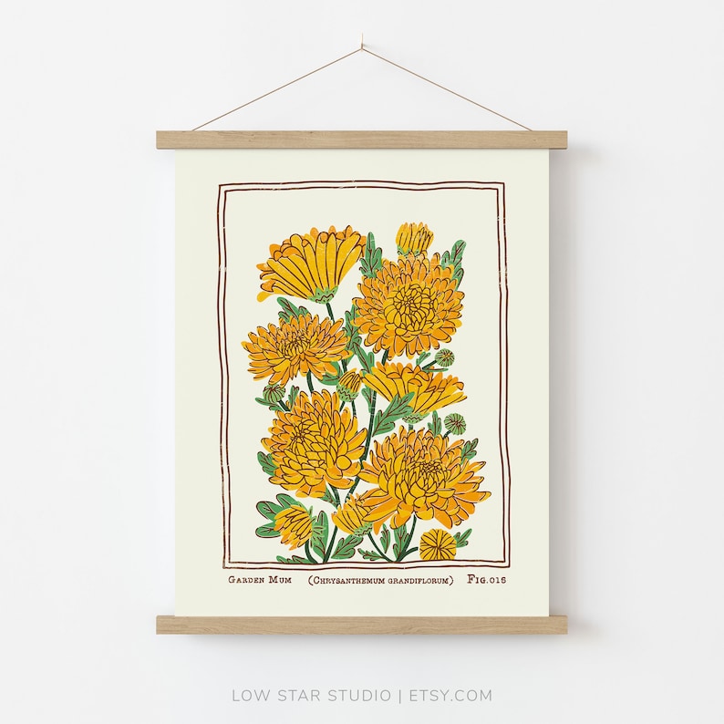 May include: A wall hanging print featuring a botanical illustration of yellow garden mum flowers with green leaves, enclosed in a brown rectangular border. The text reads Garden Mum (Chrysanthemum grandiflorum) Fig.018 at the bottom.