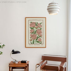May include: A framed botanical illustration of pink peonies with green leaves and stems. The print is titled "Common Peony" and has the scientific name "Paeonia officinalis" and the number "Plate 101".
