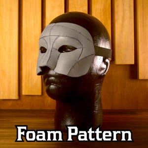 May include: A gray foam mask pattern with a black elastic strap, displayed on a black mannequin head. The mask has visible seam lines and is designed to cover the eyes and nose. The text "Foam Pattern" is at the bottom.