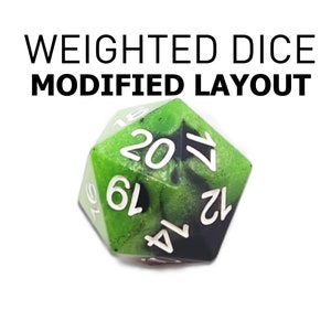 May include: A green and black polyhedral die with white numbering, featuring the text "WEIGHTED DICE MODIFIED LAYOUT". The die has a unique marbled effect and is designed for tabletop gaming.