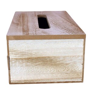 May include: A rectangular tissue box cover featuring a natural wood grain top surface with a central elongated opening and a front panel finished in a distressed white wash over a light brown wood texture, showcasing visible horizontal wood grain patterns.