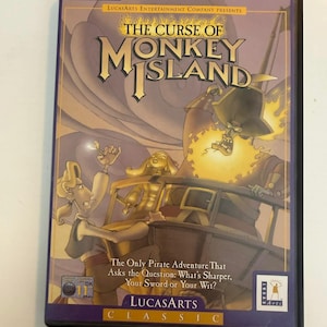 May include: A PC CD-ROM game case for "The Curse of Monkey Island." The cover art features a pirate-themed illustration with characters, a ship, and the game's title in a stylized font. The case includes the LucasArts logo and the text "Classic."