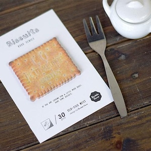May include: A pack of 30 self-stick notes shaped like a biscuit with the text "I'd rather be eating biscuits" printed on the biscuit. The notes are designed by "Biscuits Home".