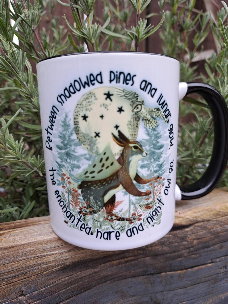 Rear perspective of the ceramic mug showcasing the continuation of the moonlit forest design, highlighting the intricate details of the pine trees and nocturnal ambiance. The seamless wrap-around artwork makes it a unique piece for witchcraft and celestial enthusiasts.