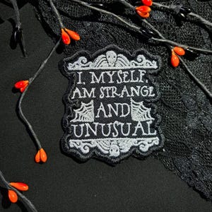 Strange and Unusual Gothic Patch | Spooky Iron-On Badge with Skulls | Horror Goth Embroidered Patch | Emo Alternative Fashion Vegan Patch