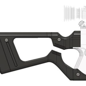 May include: Black plastic gun grip with a textured surface and a cutout for a finger. The grip has a rectangular shape with a curved bottom and a small hole on the side.