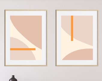 May include: Two framed abstract art prints with geometric shapes in shades of pink, beige, and orange. The prints are hanging on a white wall above a wooden dresser.