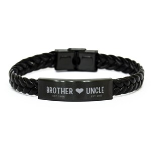 May include: Black leather bracelet with a black metal plate that reads "Brother ♥ Uncle EST. 1986 EST. 2023".
