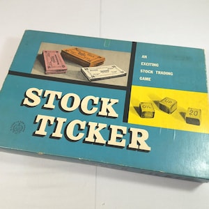 May include: A rectangular board game box titled Stock Ticker in large white letters on a blue background. The box features images of stacks of play money and three small cubes labeled Oil, Up, and 20. The text reads An Exciting Stock Trading Game.