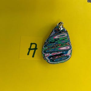 May include: A set of three ceramic nesting bowls in graduating sizes. The bowls feature a speckled, matte finish in shades of cream, light gray, and dark gray. Each bowl has a rounded shape and a slightly flared rim.