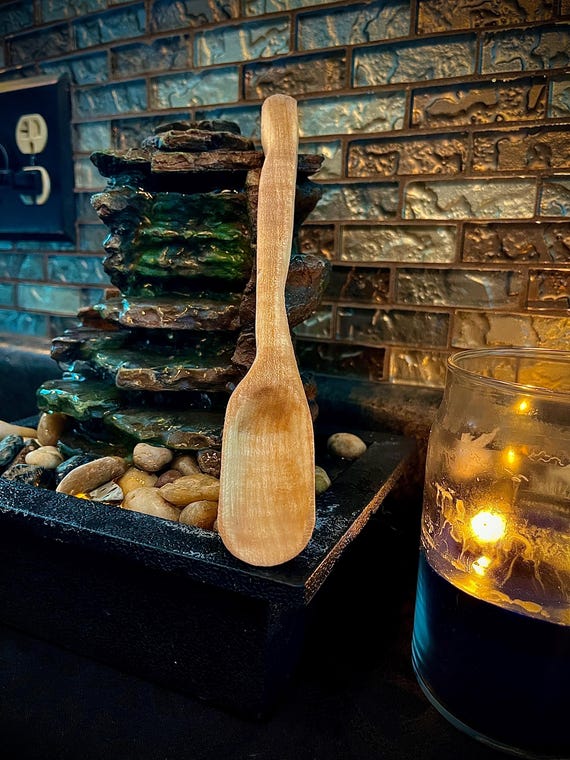 A hand-carved maple spoon with a genuinely unique sculptural silhouette — the kind of object that looks like it belongs in a craft museum, not a drawer.