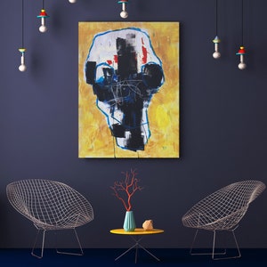 May include: An abstract painting with a yellow background and black and white shapes hangs on a dark blue wall. Two wire chairs and a small yellow table with a vase and coral-colored branches are in front of the wall. Decorative hanging lights.