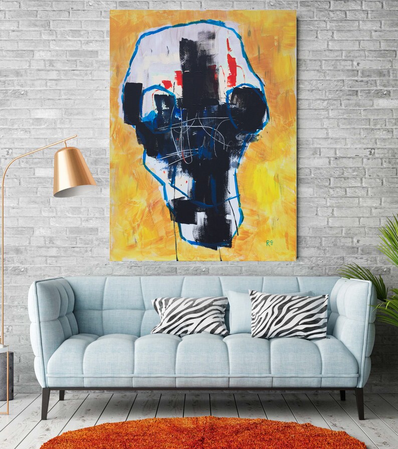May include: Abstract expressionist painting with a yellow background and a central black and white form outlined in blue. The artwork hangs above a light blue sofa with zebra-print pillows, complemented by an orange rug and a gold floor lamp.
