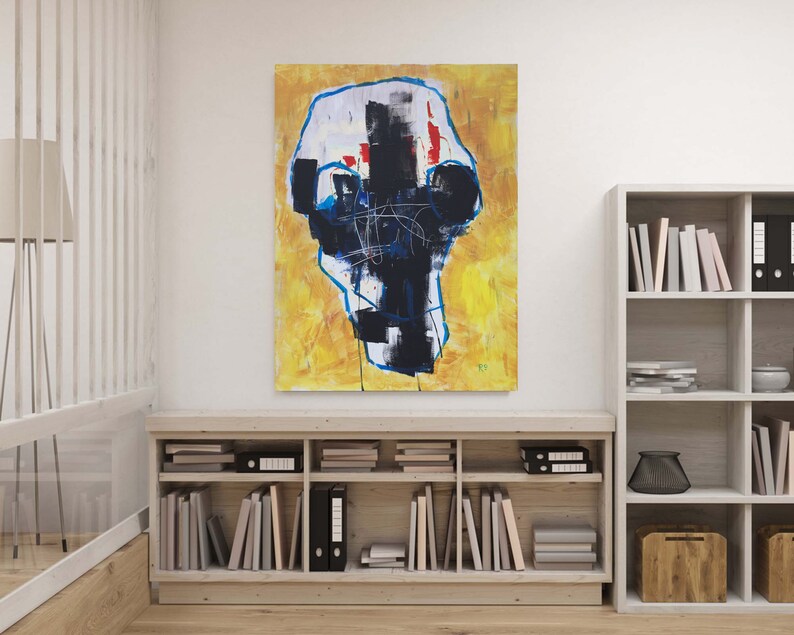 May include: Abstract painting on canvas with a yellow background and a central black and white form outlined in blue. Red accents and linear details add visual interest. The artwork is displayed above a wooden bookshelf.