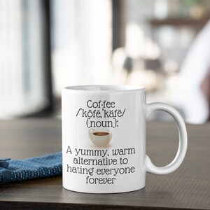 May include: White ceramic coffee mug with the word "Coffee" and its pronunciation, along with the definition "(noun): A yummy, warm alternative to hating everyone forever."