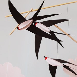 DIY Montessori mobile with black and white animal shapes hanging