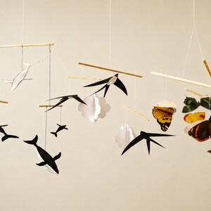 Montessori Animal Baby Mobile DIY Kit with Whale, Swallows, and Butterfly mobiles hanging against a warm neutral background for newborn visual development and visual tracking.