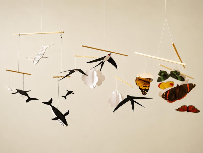 Montessori Animal Baby Mobile DIY Kit with Whale, Swallows, and Butterfly mobiles hanging against a warm neutral background for newborn visual development and visual tracking.