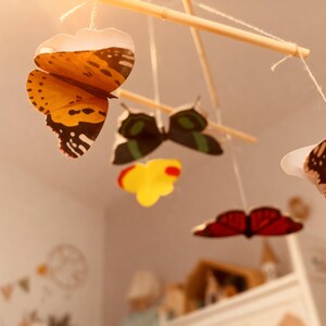 View from below of Montessori butterfly baby mobile designed for visual development and nursery decoration
