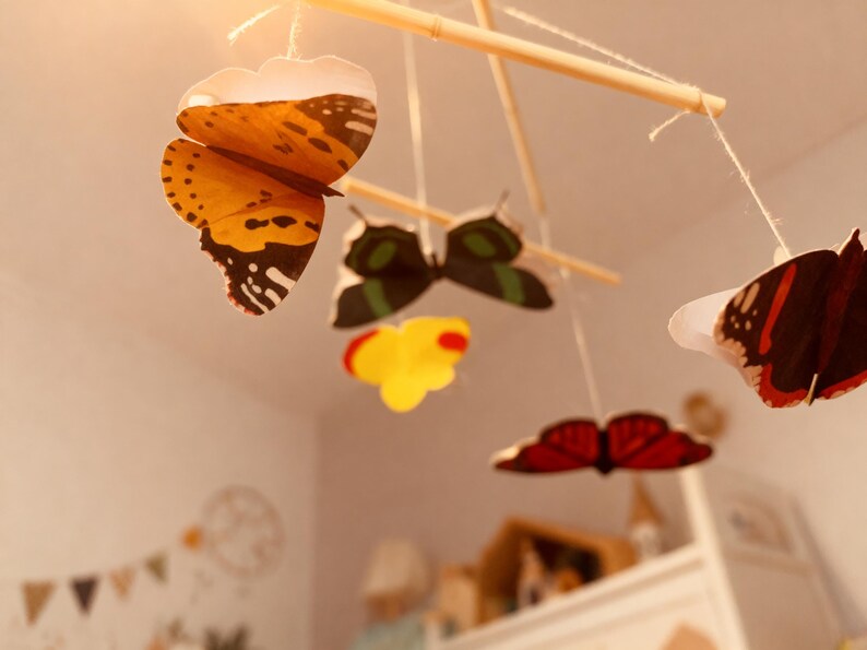 View from below of Montessori butterfly baby mobile designed for visual development and nursery decoration