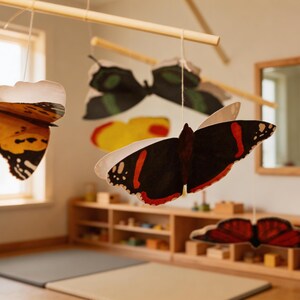 Close up of Montessori butterfly mobile with colorful paper butterflies hanging in a Montessori nursery