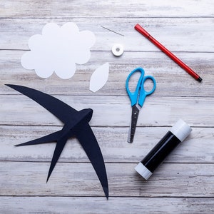 DIY Montessori Swallows Mobile – materials and printed templates needed to create the hanging mobile, laid out before assembly.