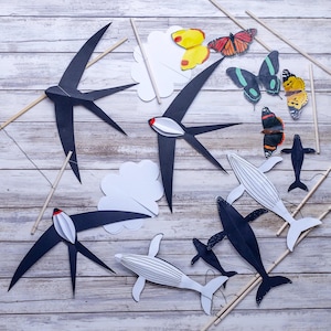 Finished DIY Montessori Animal Mobile, featuring black and white swallows, butterflies, and whales for newborn visual development