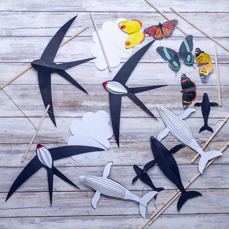 Finished DIY Montessori Animal Mobile, featuring black and white swallows, butterflies, and whales for newborn visual development