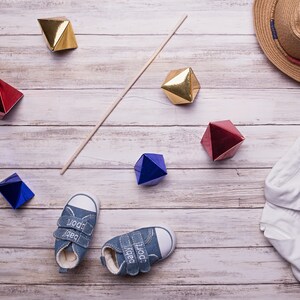 The DIY Montessori Octahedron baby mobile with some baby clothes for props