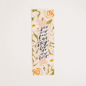 May include: A pink floral bookmark with the text "Seek His face and stay close to His heart".