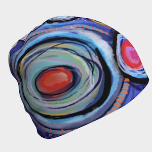 May include: A beanie hat with an abstract design. The hat features a vibrant mix of colours, including blue, red, orange, and green, arranged in swirling patterns. The design has a painted look, with visible brushstrokes and a textured appearance.