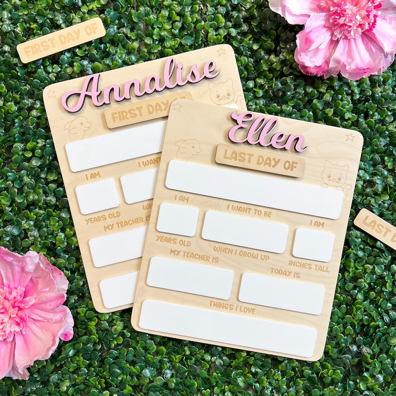 May include: Two wooden signs with blank spaces for writing. The signs are decorated with stars and animal illustrations. The top sign says "Annalise First Day" and the bottom sign says "Ellen Last Day Of".