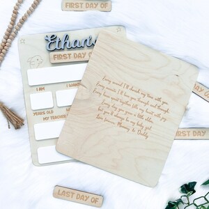 May include: A wooden plaque with a personalized message for a child's first day of school. The plaque has a space to fill in the child's age, teacher's name, and other details. The message reads: "Every second I'll cherish my time with you. Every minute I'll love you through and through. Every hour spent together fills my heart with joy. Every day you grow a little older, but you'll always be my baby girl. Love forever. Mommy & Daddy."