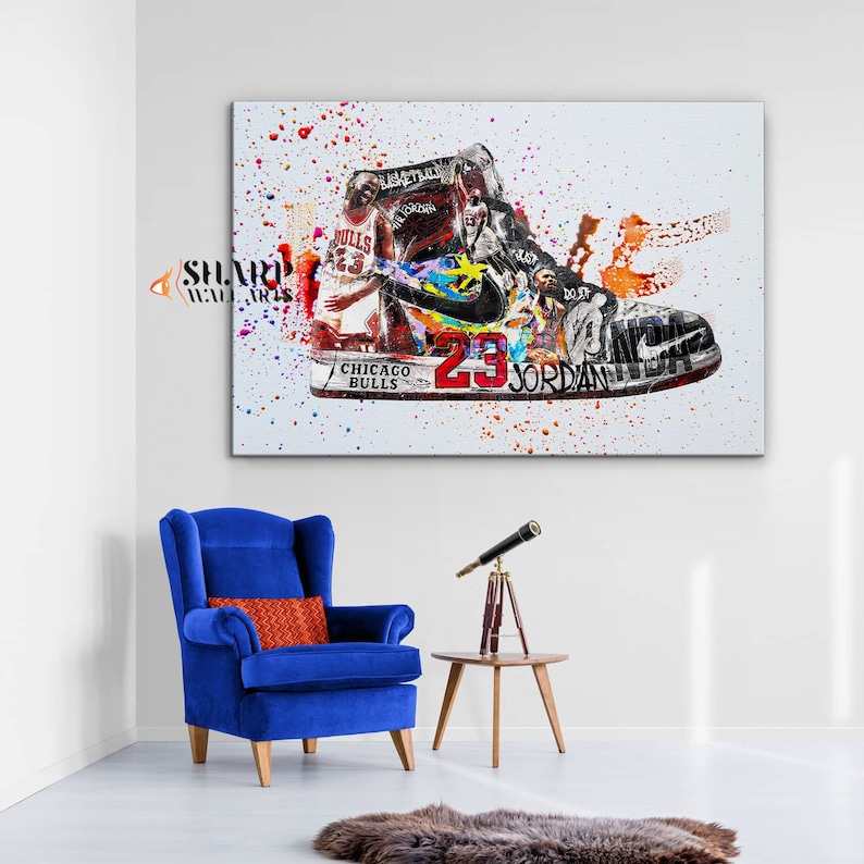 May include: A colorful abstract painting of a basketball shoe with a basketball player in the background. The shoe is a white, black, and red Air Jordan with the number 23 and the words "Chicago Bulls" and "Jordan" on it. The background is a white canvas with splashes of paint in various colors.